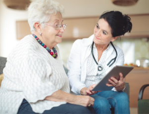 elderly woman talking with female rehabiliation specialist